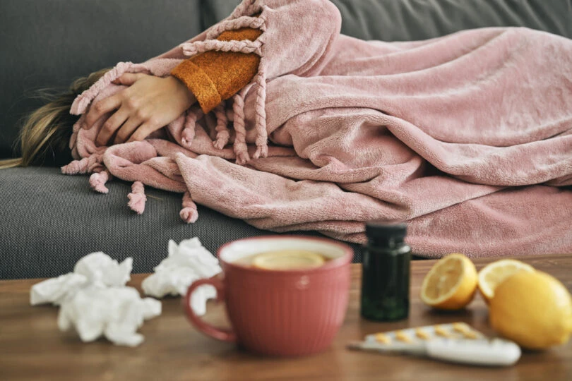 exhausted-ill-woman-lying-on-sofa-and-covering-her-2022-01-19-00-09-39-utc-810x540